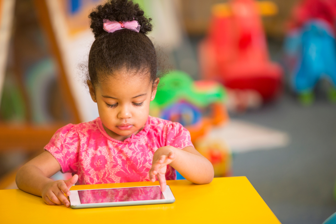 young girl learning her abc's on a tablet